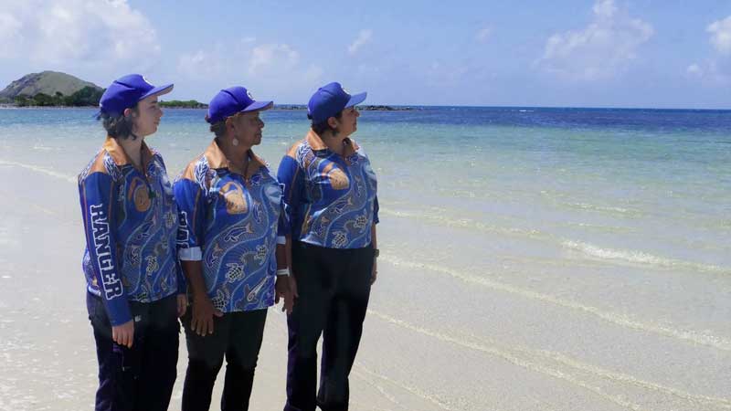 Indigenous Women of the Great Barrier Reef look into the ocean